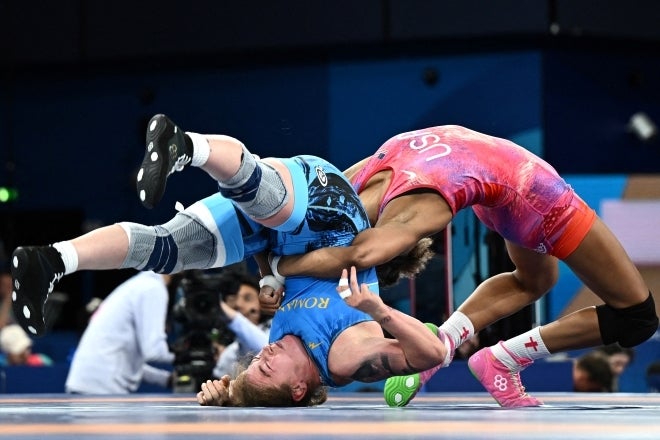 女子レスリングで鮮やかに決まった大技。会場は悲鳴と歓声に包まれた。(C)REUTERS/AFLO