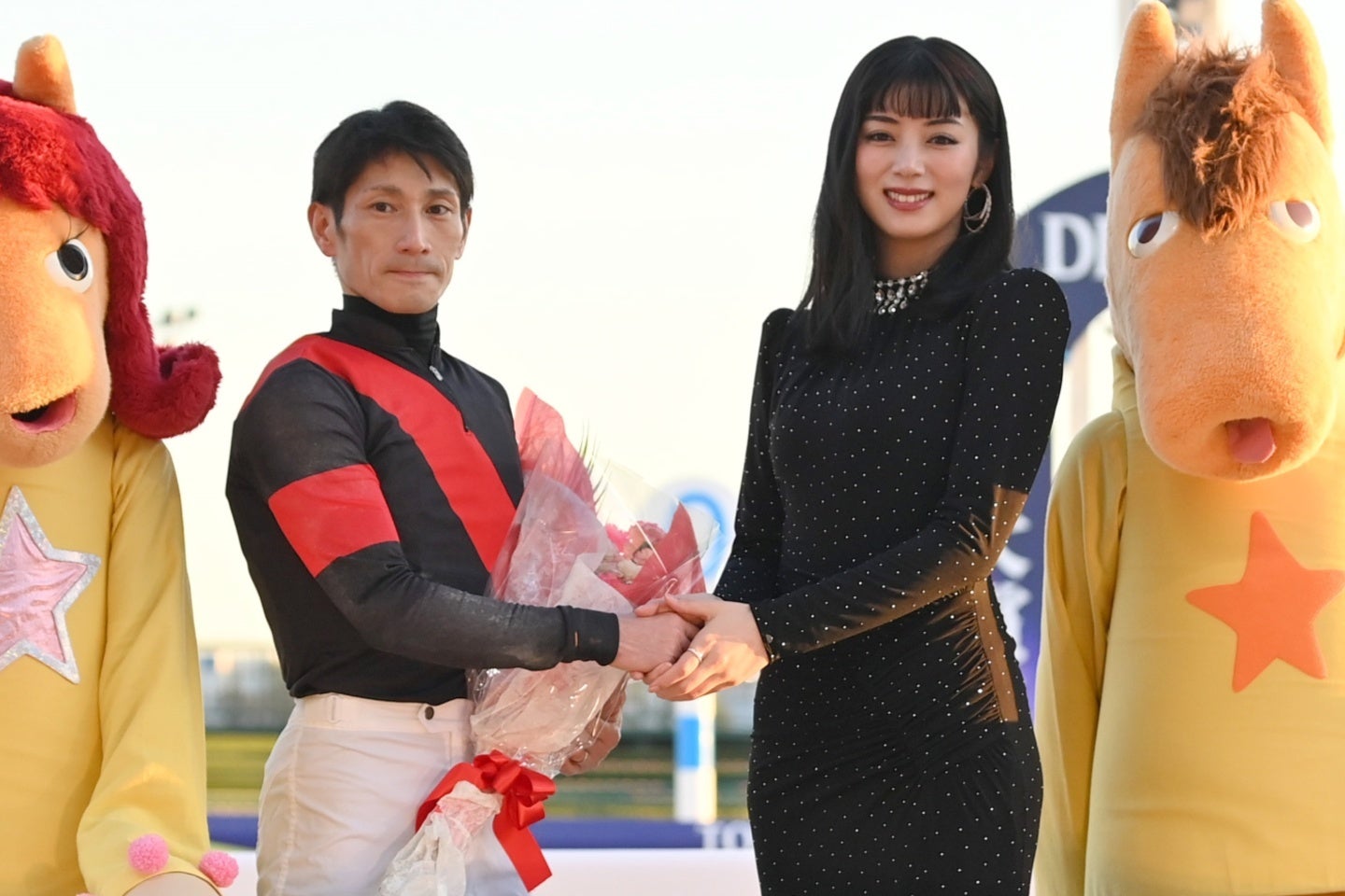 勝利ジョッキーの矢野貴之騎手と握手する俳優の池田エライザ。写真：産経新聞社