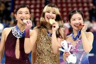 表彰台で笑顔をみせる坂本（左）、リウ（中央）、中井（右）のメダリストたち。女子シングルの美しき競演に世界が酔いしれた。(C)Getty Images