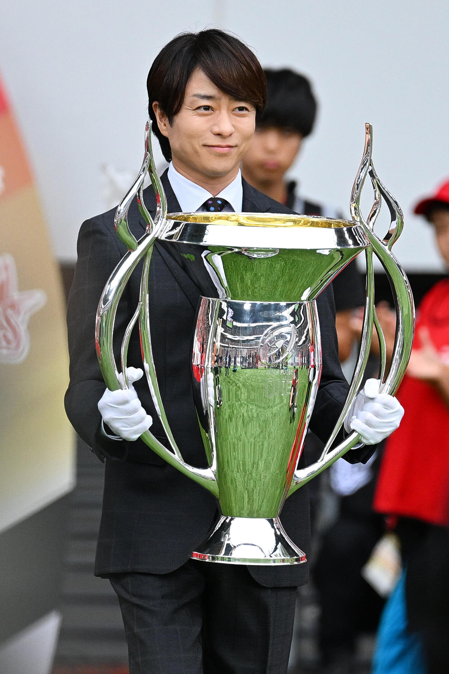 ラグビーリーグワンPO決勝の試合前、優勝トロフィーを持って国立競技場に来場した嵐の櫻井翔さん。写真：松尾/アフロスポーツ